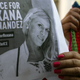 Woman holds #JusticeforRoxsana flyer at a march in her honor